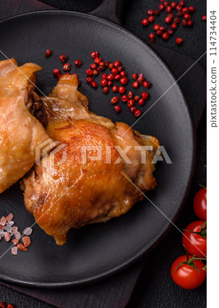 Delicious juicy chicken thighs baked on the grill with salt 114734404