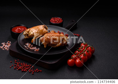 Delicious juicy chicken thighs baked on the grill with salt 114734406