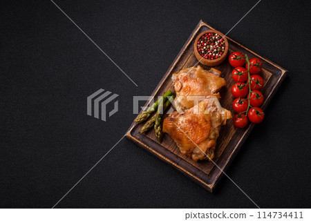 Delicious juicy chicken thighs baked on the grill with salt 114734411