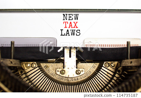 New tax laws symbol. Concept words New tax laws typed on an old retro typewriter on a beautiful white paper background. Business new tax laws concept. Copy space. 114735187