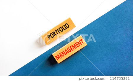 Portfolio management symbol. Concept words Portfolio management on beautiful wooden block. Beautiful blue and white paper background. Business Portfolio management concept. Copy space. 114735251