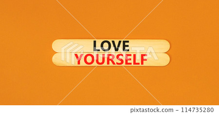 Love yourself symbol. Concept words Love yourself on beautiful wooden stick. Beautiful orange table orange background. Psychology love yourself concept. Copy space. 114735280