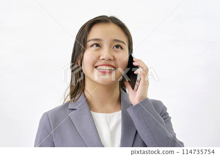 Young business woman calling on smartphone, white background 114735754