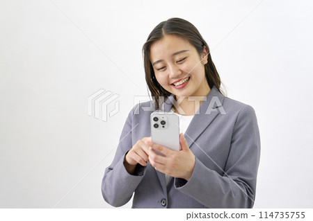 Young business woman using a smartphone on a white background 114735755