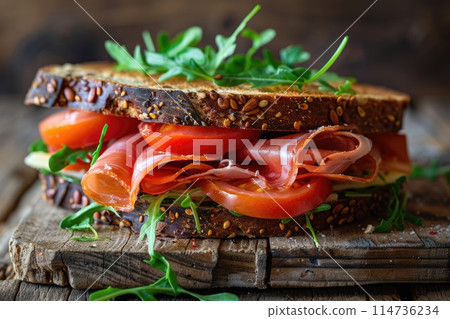 Sandwich with prosciutto, tomato and cheese on a wooden rustic background. Sandwich with prosciutto, tomato and cheese on a wooden rustic background. 114736234