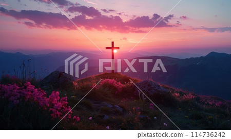 Silhouette of a cross on a hill in a mountain landscape at sunset. 114736242