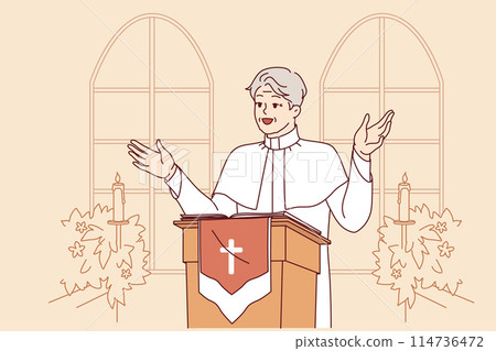Man priest with smile leads sermon in catholic church, standing behind podium with crucifix 114736472