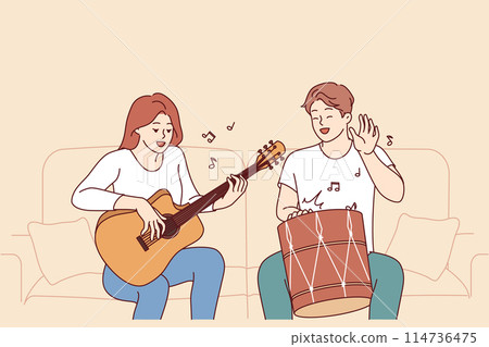 Cheerful friends playing musical instruments, sitting on sofa and using drum with guitar Cheerful friends playing musical instruments, sitting on sofa and using drum with guitar 114736475