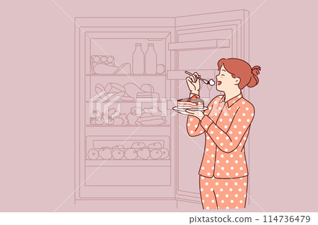 Woman eats cake at night, standing in pajamas near open refrigerator and risking becoming overweight Woman eats cake at night, standing in pajamas near open refrigerator and risking becoming overweight 114736479