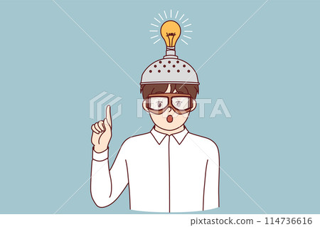 Inspired boy invented new idea and shows finger up standing with funny helmet with light bulb 114736616
