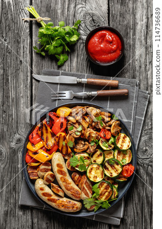 grilled white sausages with veggies and mushrooms 114736689