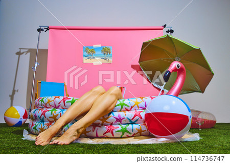Person enjoying laid-back moment in inflatable pool. Cheerful and carefree summer vibe. Concept of travelling, party time. Person enjoying laid-back moment in inflatable pool. Cheerful and carefree summer vibe. Concept of travelling, party time. 114736747