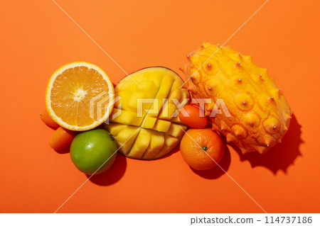 Set of tropical fruit on orange background, top view 114737186