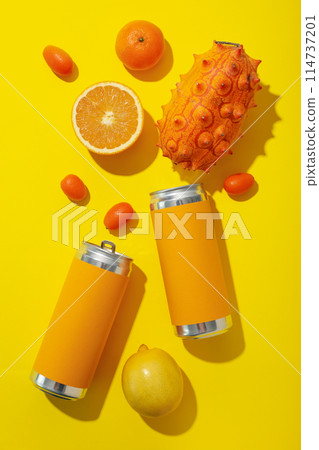 Tropical fruit and tin cans on yellow background, top view Tropical fruit and tin cans on yellow background, top view 114737201