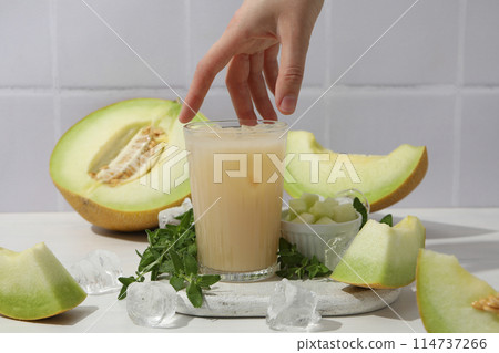 Slices of fresh melon with a glass of juice Slices of fresh melon with a glass of juice 114737266
