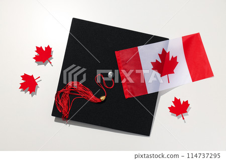Graduate hat with Canadian flag on light background Graduate hat with Canadian flag on light background 114737295