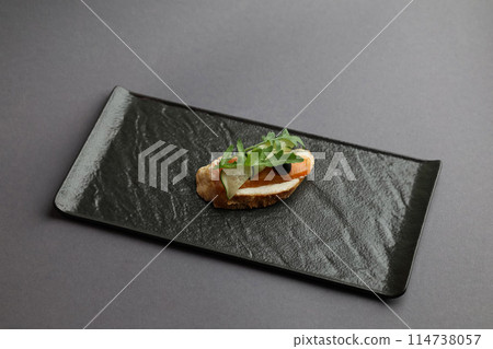 Tasty bruschetta with salmon. Salmon toast with cream cheese, arugula and dark olive Tasty bruschetta with salmon. Salmon toast with cream cheese, arugula and dark olive 114738057
