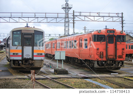 Kiha 120 and Kiha 47 diesel railcars lined up at a rail depot (JR West) Kiha 120 and Kiha 47 diesel railcars lined up at a rail depot (JR West) 114738413