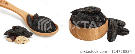 Tonka bean in wooden spoon and bowl isolated on white background with full depth of field. Bean of Dipteryx odorata Tonka bean in wooden spoon and bowl isolated on white background with full depth of field. Bean of Dipteryx odorata 114738824