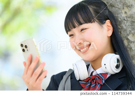 High school girl with smartphone, headphones 114739344