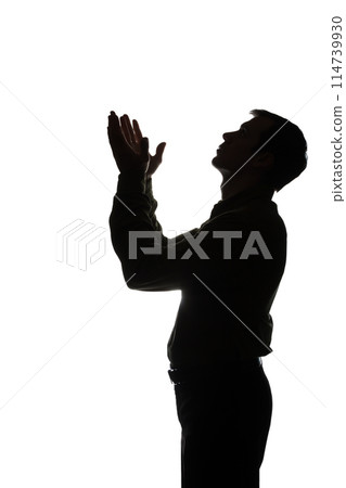 Young man looking up with hope and request - silhouette Young man looking up with hope and request - silhouette 114739930