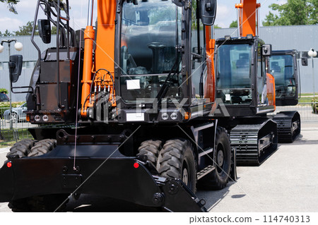 Fleet of heavy construction excavators Fleet of heavy construction excavators 114740313
