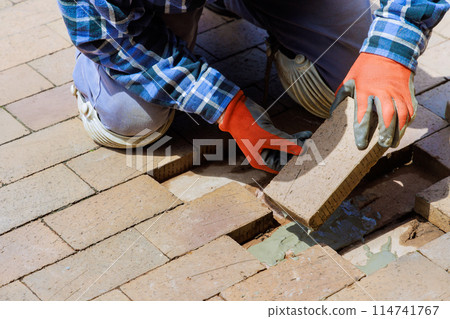 Pavement that has been destroyed by brick path is being rebuilt as replacement 114741767