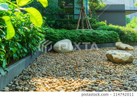 The garden next to the house is filled with many small rocks. 114742011
