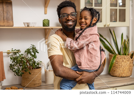 African American man enjoying leisure time with his daughters African American man enjoying leisure time with his daughters 114744009