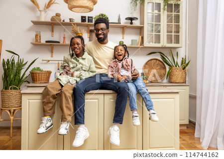 Cheerful dad with happy little children daughters having fun at home 114744162