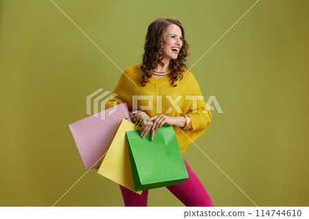 smiling trendy female isolated on green background smiling trendy female isolated on green background 114744610
