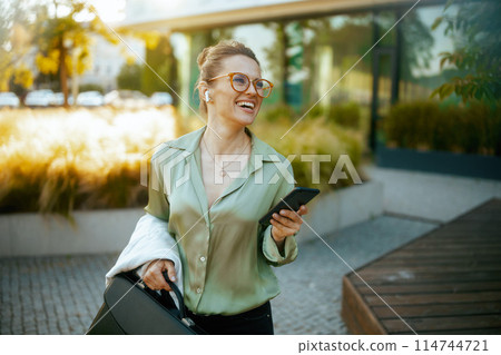 smiling modern business woman in green blouse and eyeglasses smiling modern business woman in green blouse and eyeglasses 114744721