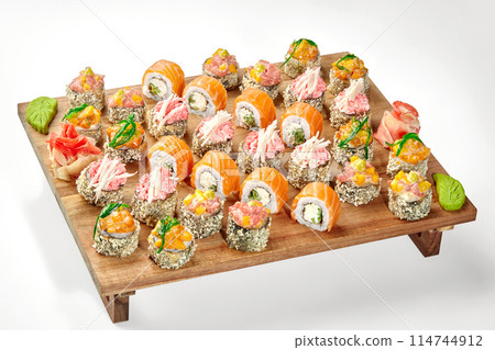 Delicious set of sushi rolls with various toppings on wooden tray 114744912