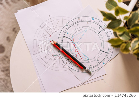 Natal chart on white paper with pencils on the table 114745260