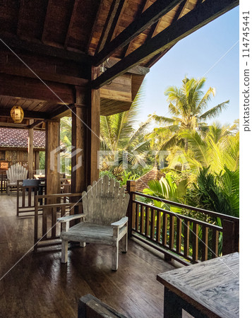 Balcony in a wooden house with wooden furniture Balcony in a wooden house with wooden furniture 114745441