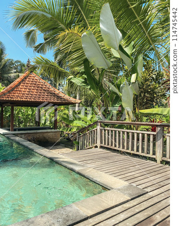 Swimming pool and traditional Balinese gazebo 114745442