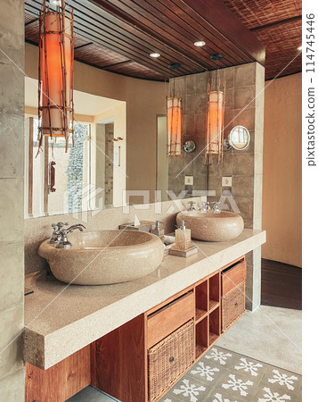 Two luxury faucet mixer on a round bowl stone sink Two luxury faucet mixer on a round bowl stone sink 114745446