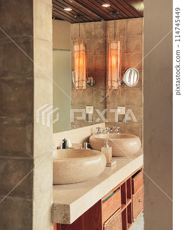 Two luxury faucet mixer on a round bowl stone sink Two luxury faucet mixer on a round bowl stone sink 114745449