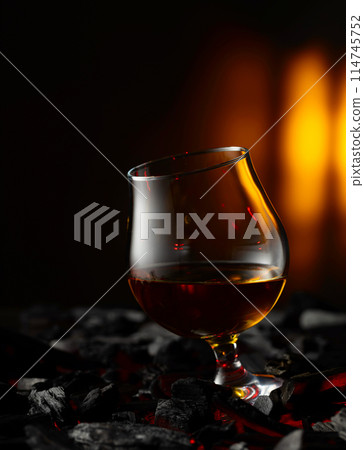 Snifter of brandy on a burning charcoal. 114745752