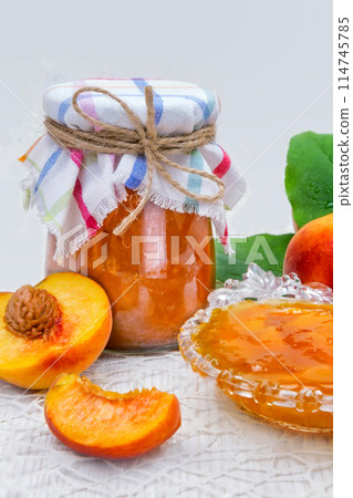 Peach jam in the jar on the table 114745785