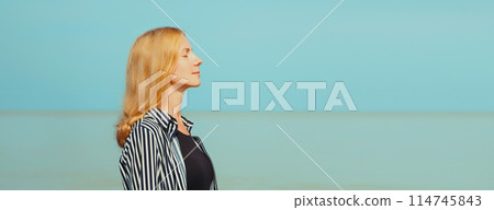 Calm relaxing healthy woman meditates, practicing breathing exercises on sea Calm relaxing healthy woman meditates, practicing breathing exercises on sea 114745843