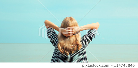 Summer vacation, happy relaxing woman meditates on the beach on sea Summer vacation, happy relaxing woman meditates on the beach on sea 114745846