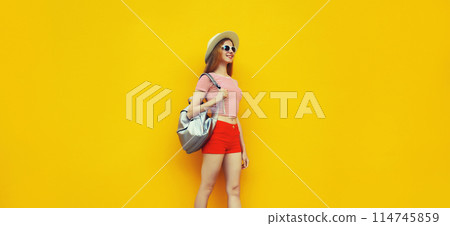 Beautiful young woman full length standing in summer straw hat with backpack Beautiful young woman full length standing in summer straw hat with backpack 114745859