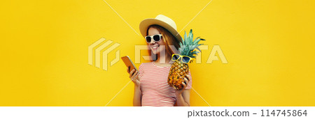 Summer portrait of traveler young woman with smartphone holding pineapple fruit Summer portrait of traveler young woman with smartphone holding pineapple fruit 114745864