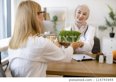 Arab female doctor makes treatment plan for gastrointestinal tract. Arab female doctor makes treatment plan for gastrointestinal tract. 114745944