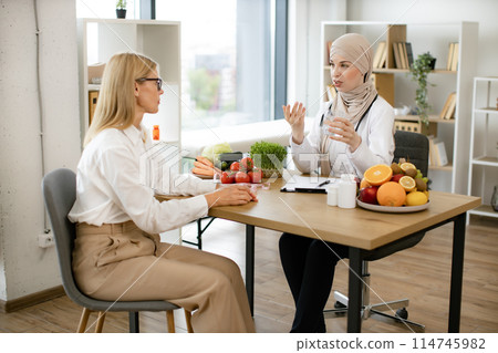 Muslim doctor holds demonstrate importance of replenishing fluids in diet. Muslim doctor holds demonstrate importance of replenishing fluids in diet. 114745982