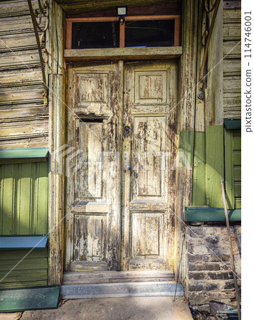 Old building wooden door with textured surface, a hole for mail and a round handle Old building wooden door with textured surface, a hole for mail and a round handle 114746001