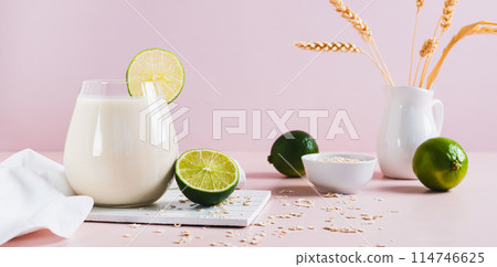 Homemade oatzempic drink of oat milk and lime in a glass on the table web banner 114746625
