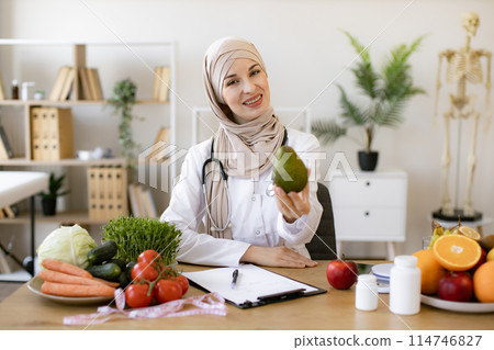 Arabian female nutritionist making healthy eating plan. Arabian female nutritionist making healthy eating plan. 114746827