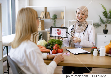 Beautiful adult woman at appointment with family nutritionist. Beautiful adult woman at appointment with family nutritionist. 114746846